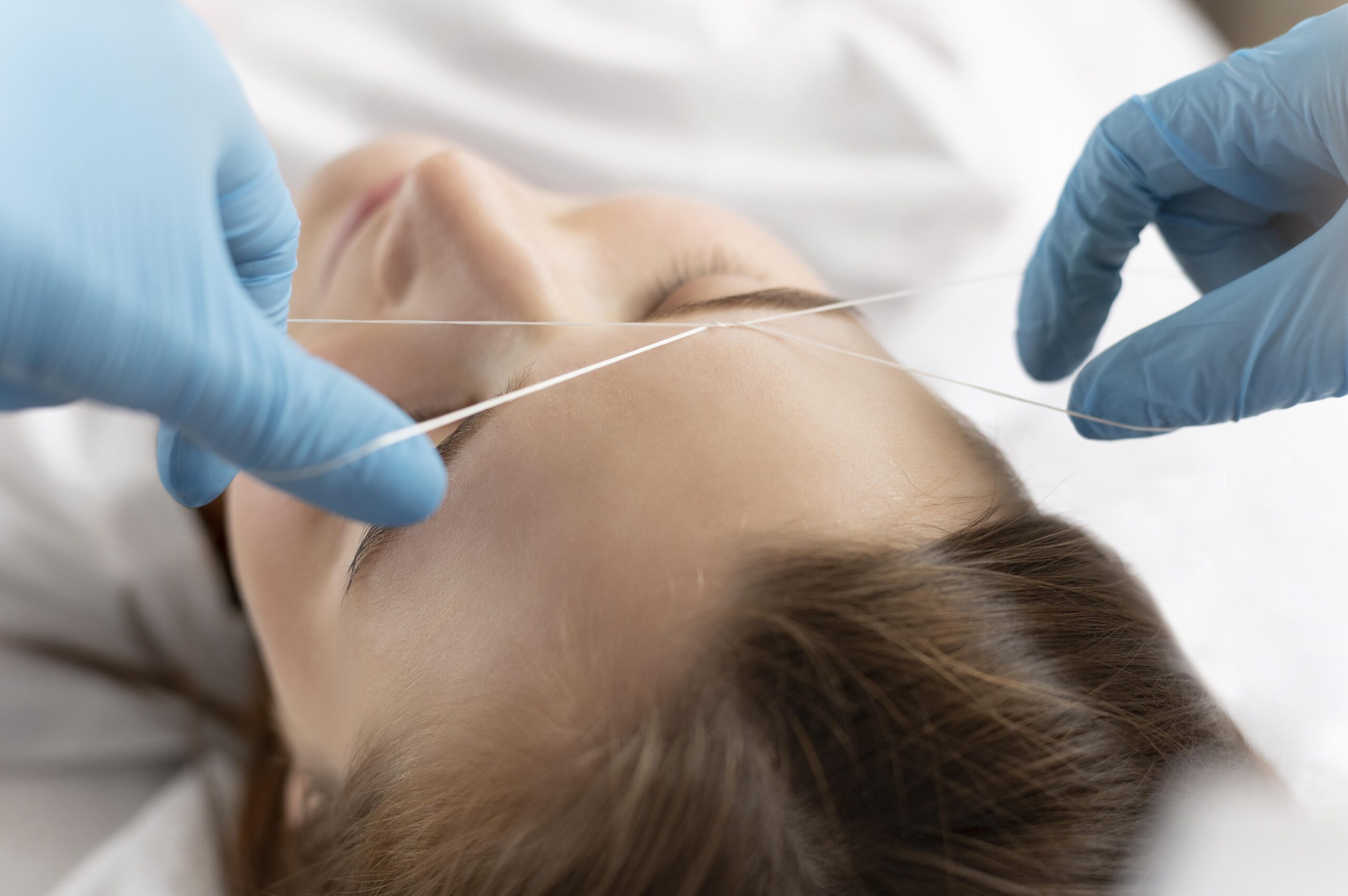 close-up-young-woman-getting-eyebrow-treatment