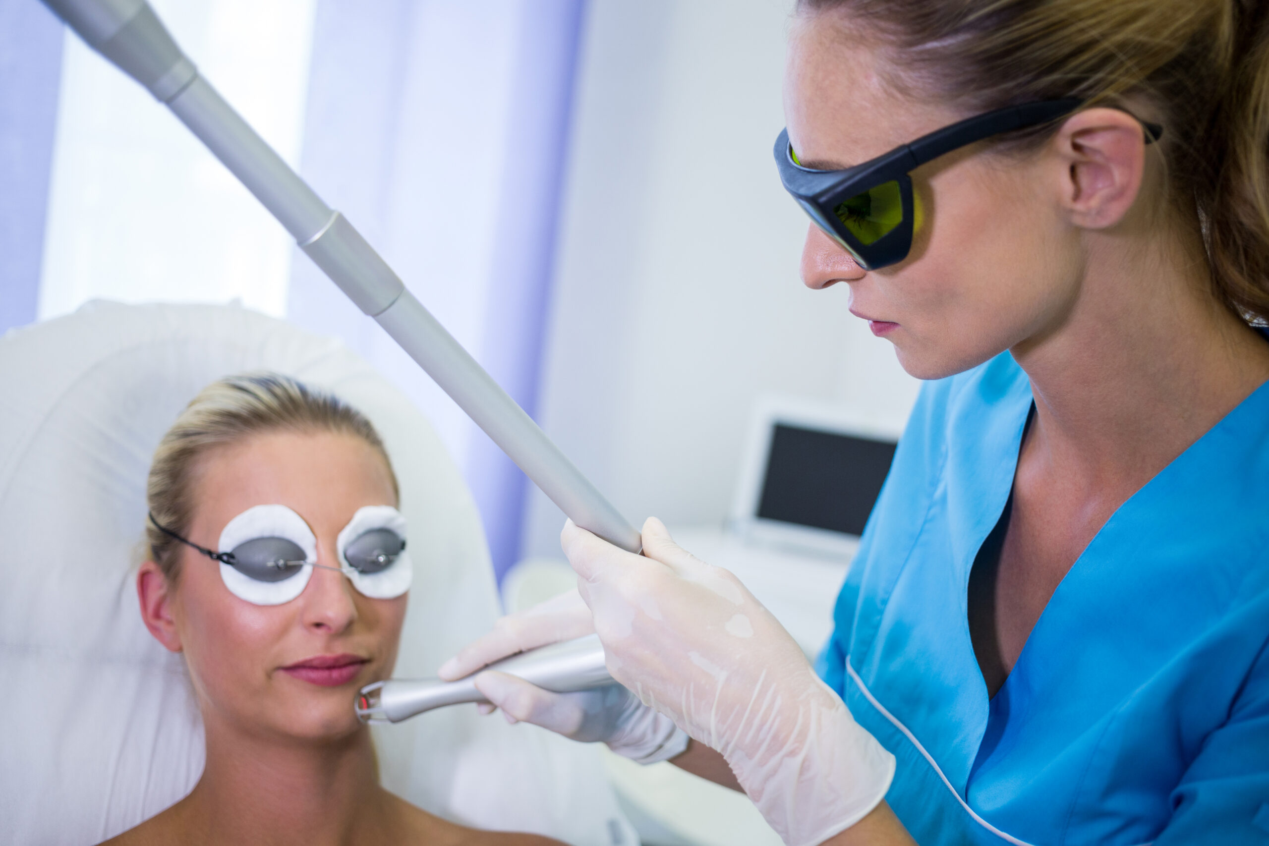 Female patient getting rf lifting procedure in a beauty saloon